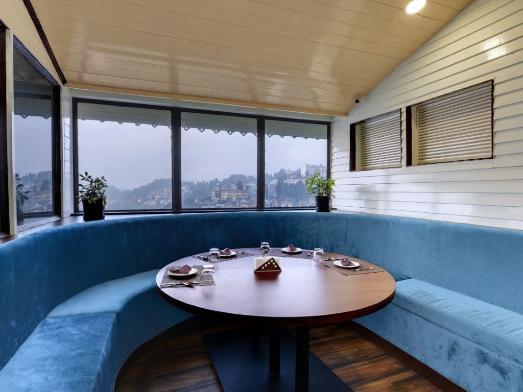 Lobby image of Sumitel Darjeeling featuring a round lounge seating with a round table