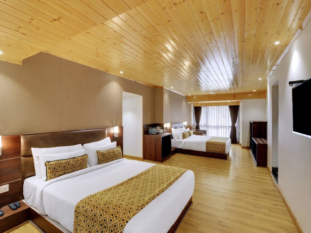 An image of a room with two queen size beds, TV and minimal decoration - Sumitel Vista TV Tower