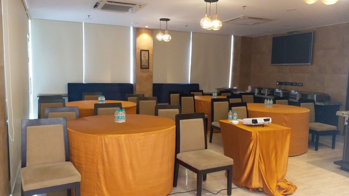 Chairs and round tables at a restaurant | Hotel Mumbai House, Andheri East