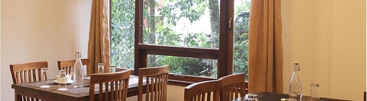 Seating arrangements next to the window inside the Restaurant - Ecotel Chiminda