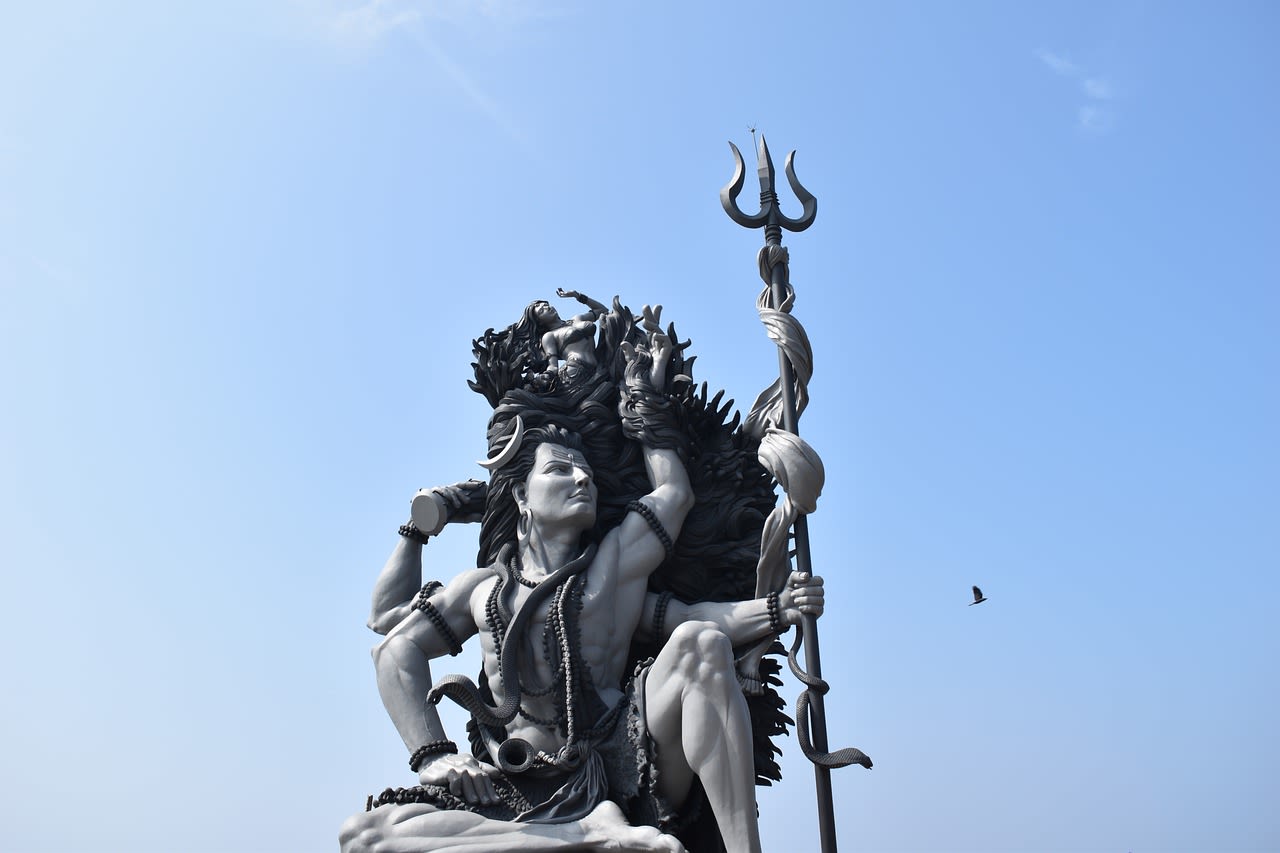 a statue of shiva holding a trident