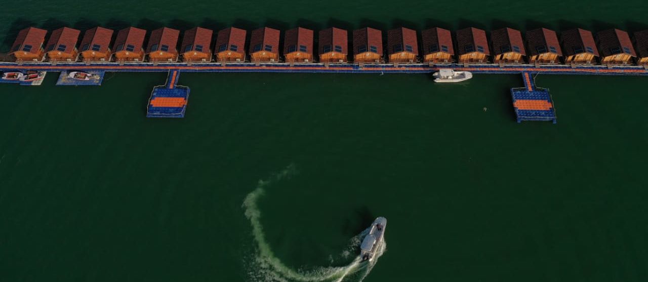 ariel and front view of the floating huts at Le ROI Floating Huts Eco Rooms captured during the day and at night13