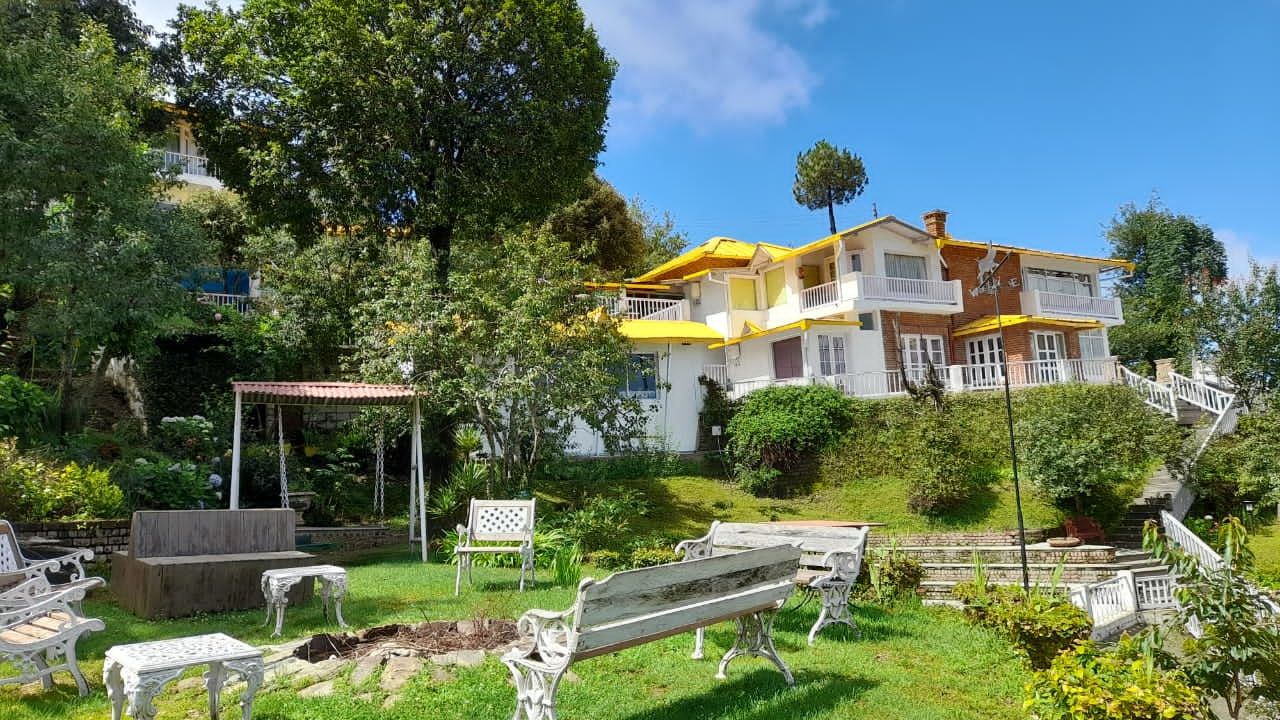 Exterior view of Te Aroha by Shervani Mukteshwar with benches surrounding a fireplace