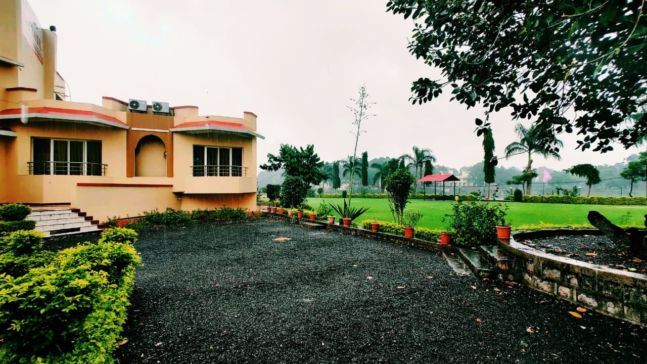 View of the property surrounded by beautiful lush green lawn - TGI Jahaj Mahal Mandu woqayl