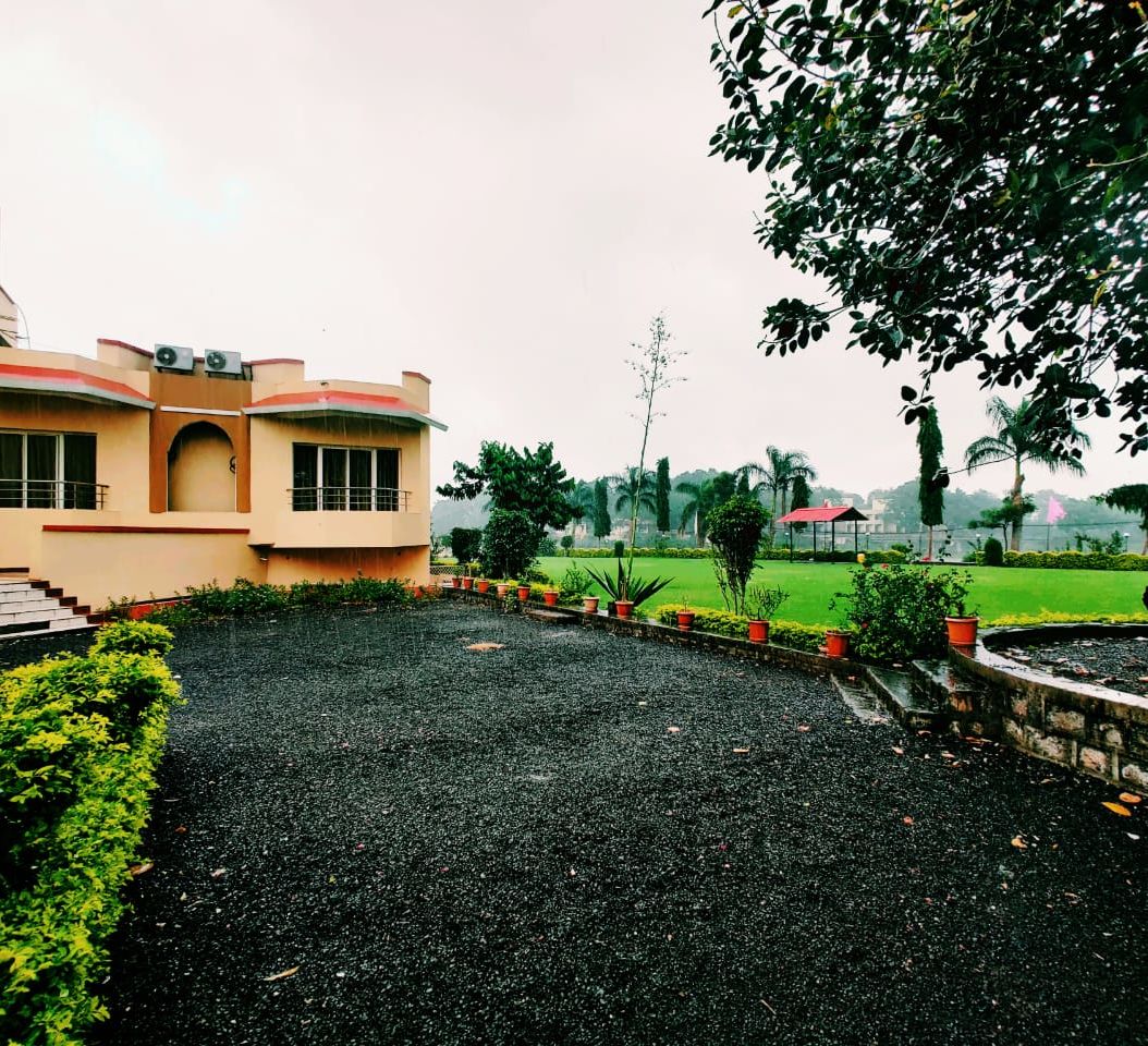 View of the property surrounded by beautiful lush green lawn - TGI Jahaj Mahal Mandu woqayl