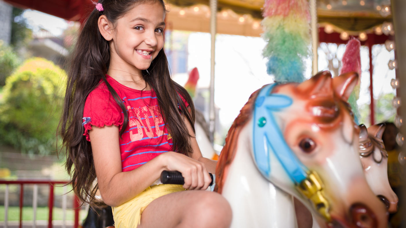 Kid riding a pony merry-go-round