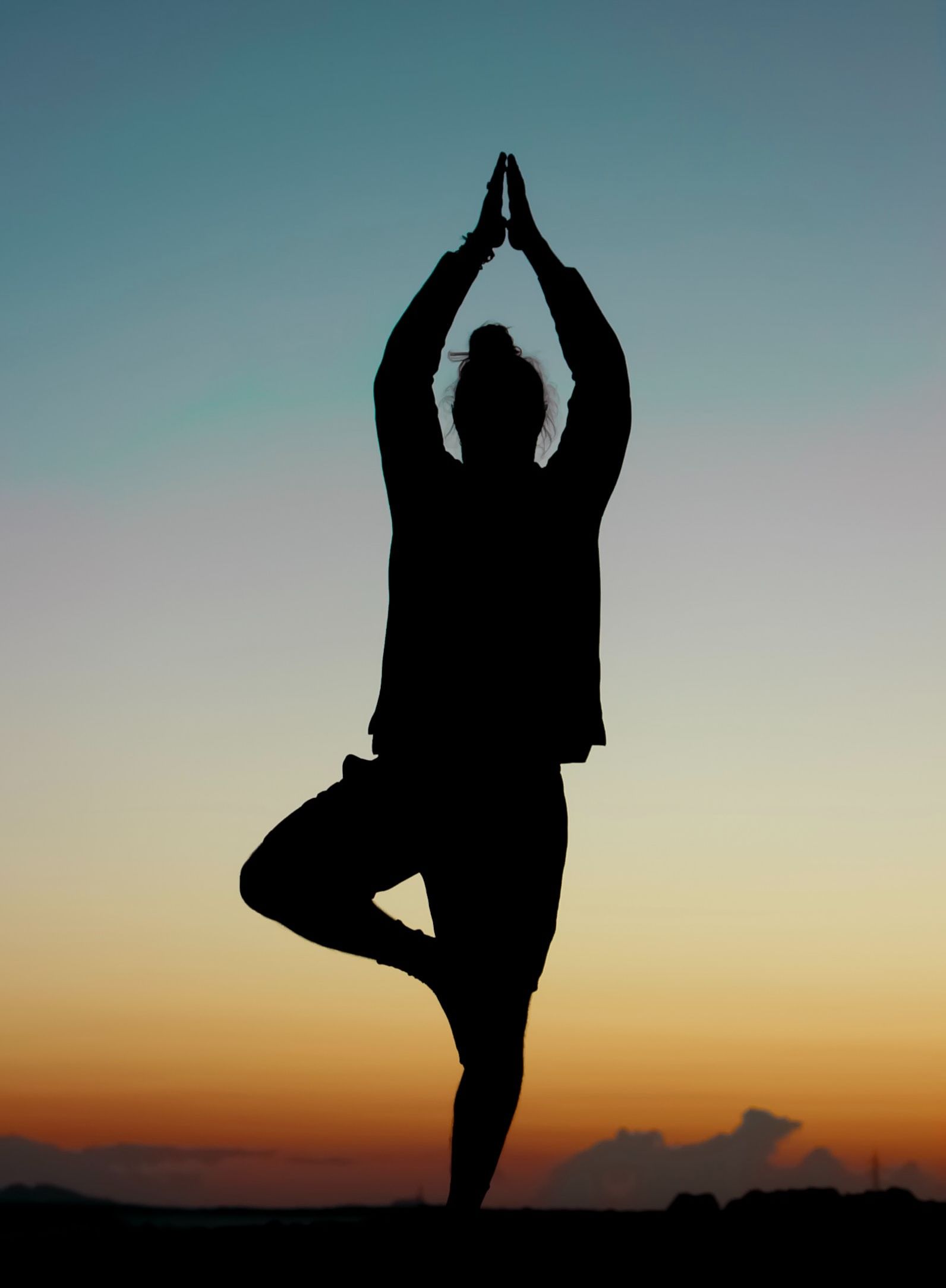 silhouette of a person doing yoga