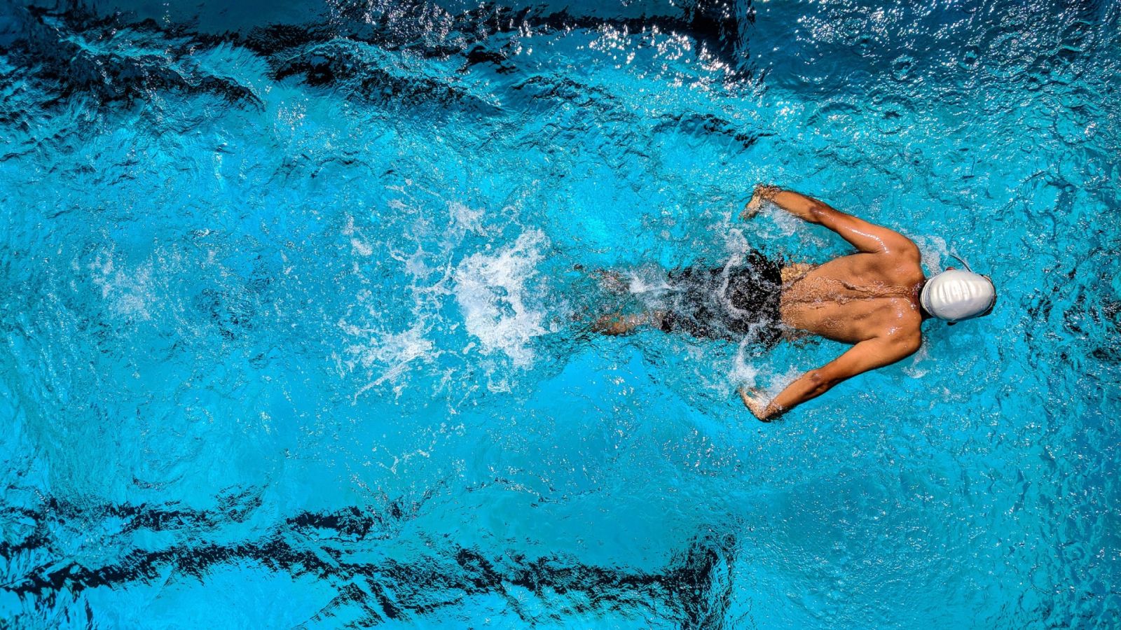 A person swimming in a swimming pool - Rhythm Gurugram
