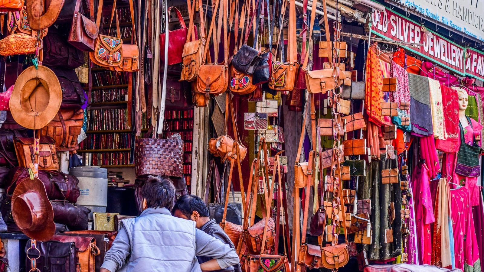 people shopping in a stall at a local market selling handicrafts