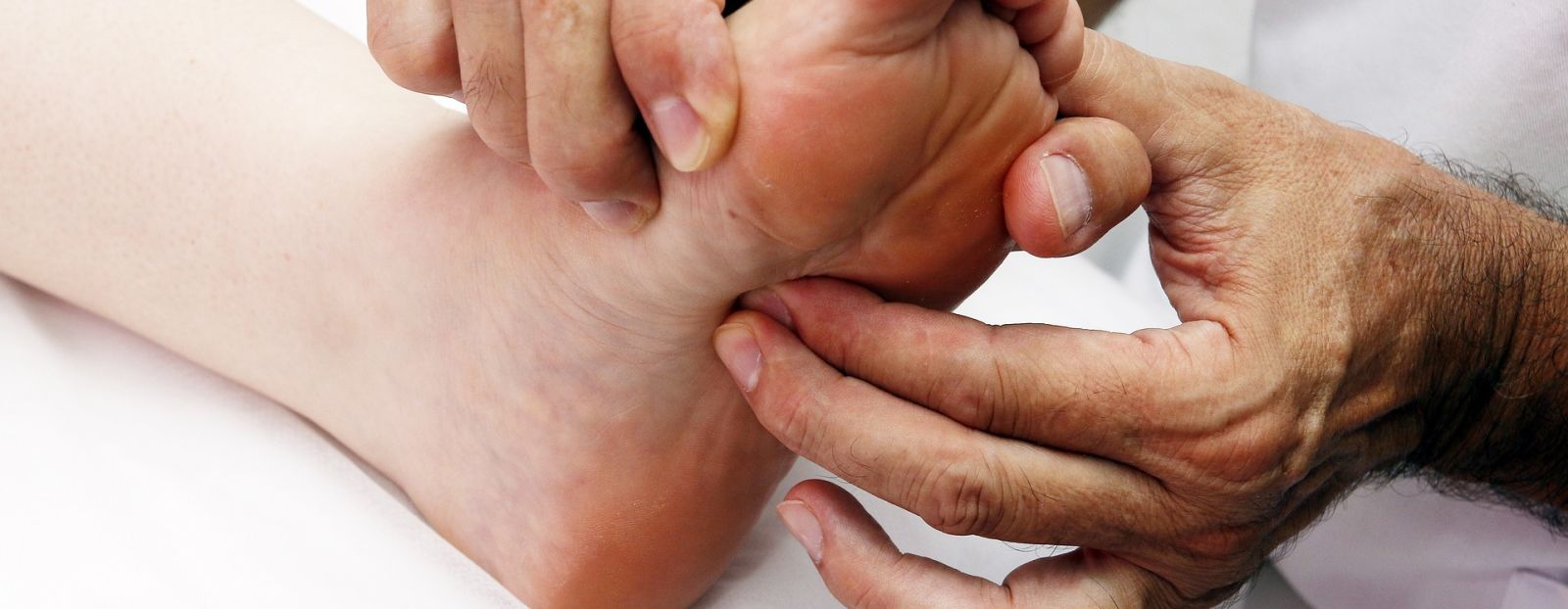 a massage therapist providing a foot massage