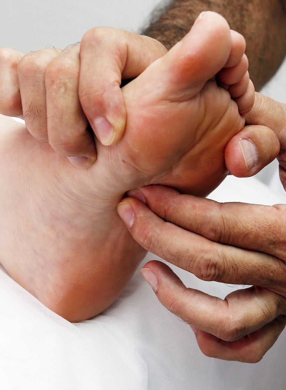 a massage therapist providing a foot massage