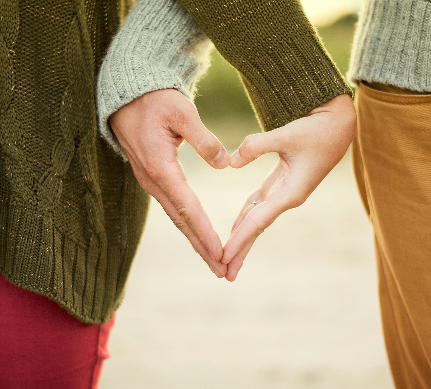 A couple s intertwined hands make a heart shape - best resort in Rishikesh for couples