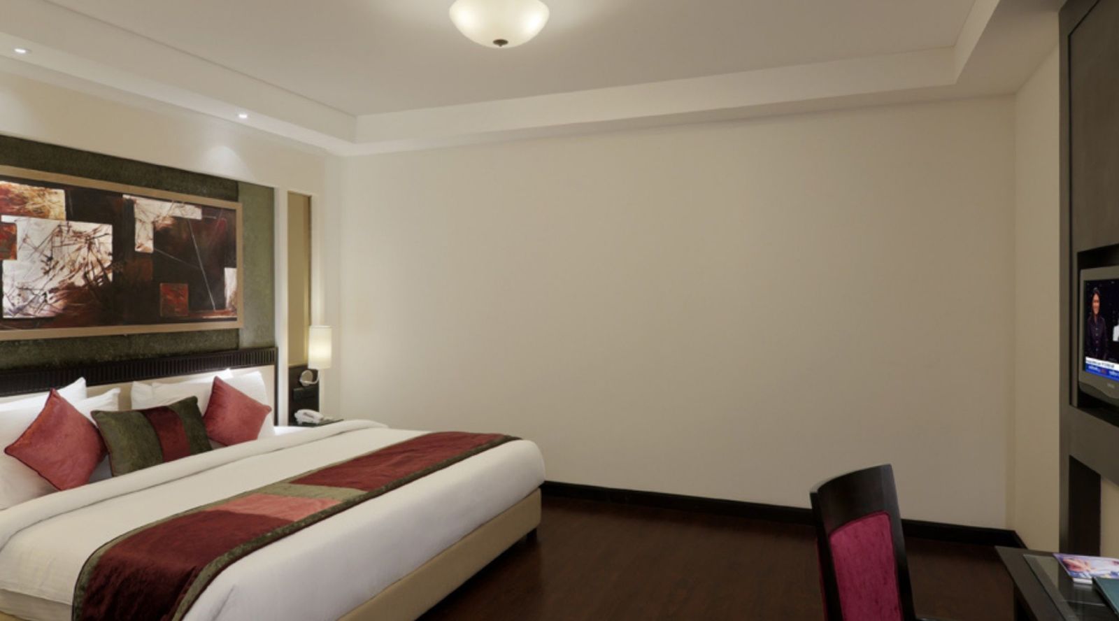 view of large size bed in Suite room of Inde Hotel Vista Woods, Gurgaon 