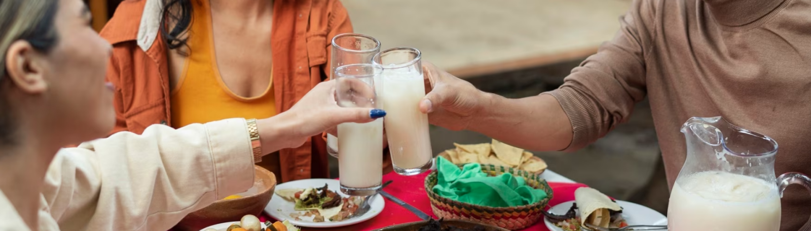 people clinking their glasses with a drink