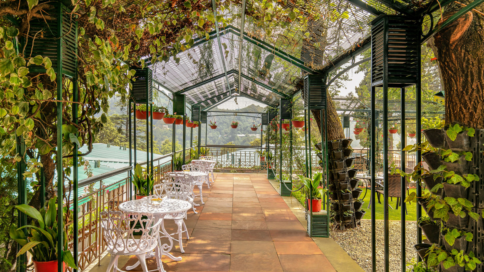 A charming outdoor seating area with a view of the mountains and valley.