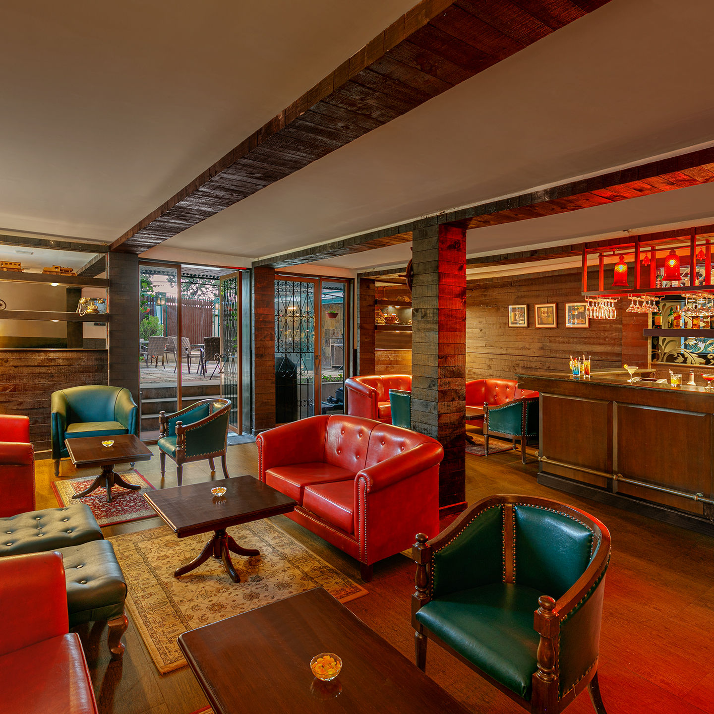  A image of a resturant with tred lighting with table and chair setting well decorated with bar also present at Shervani Hiltop 