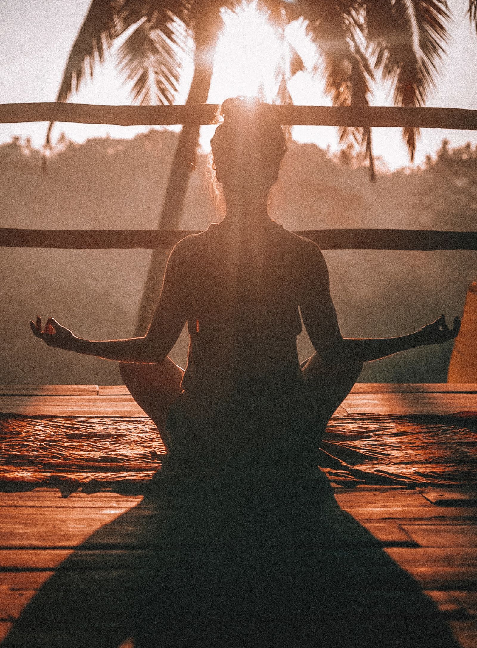 A woman practices meditation on a sunny day - monsoon and ayurveda - Gamyam Retreat