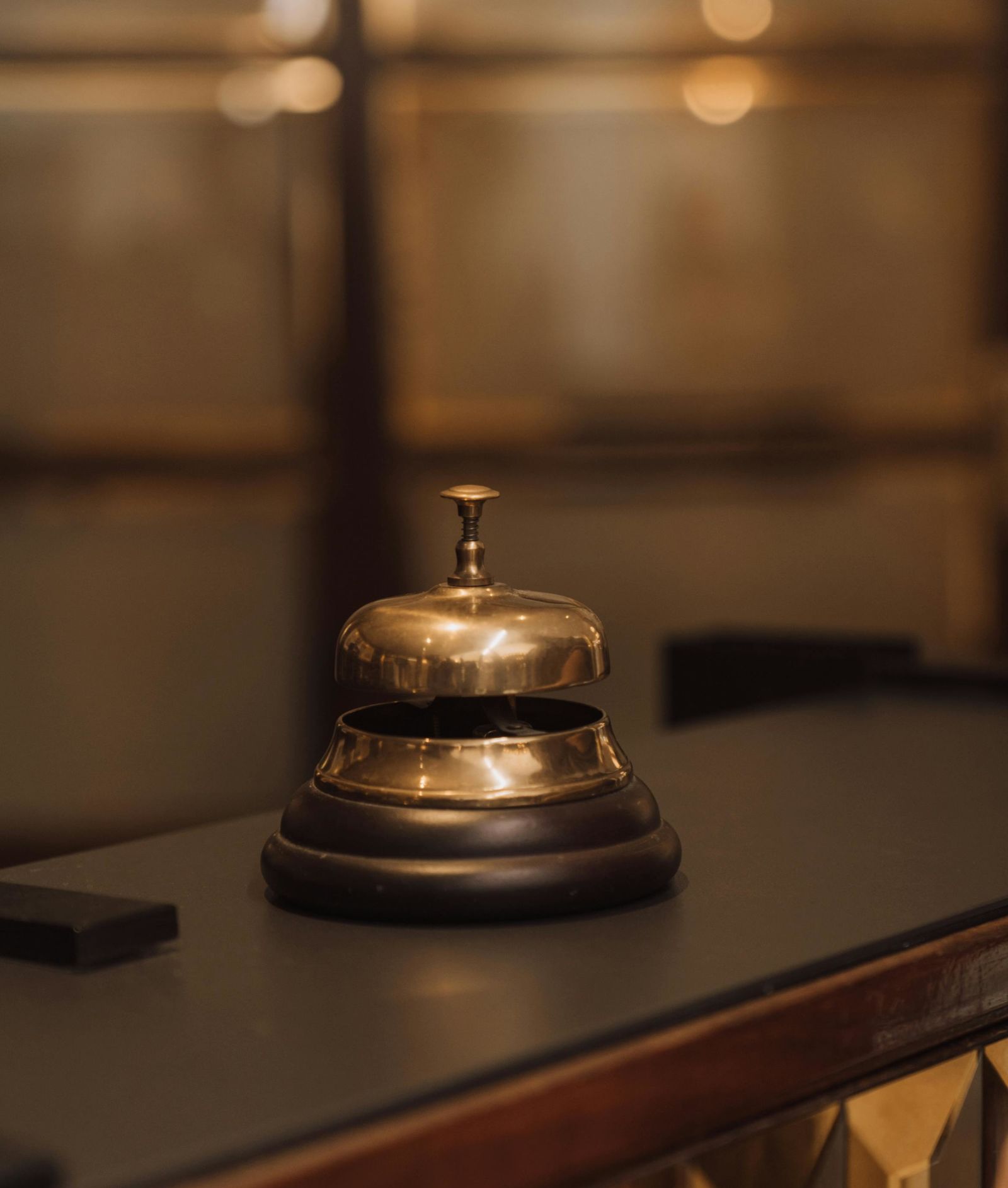 A bell placed on a front desk of a hotel