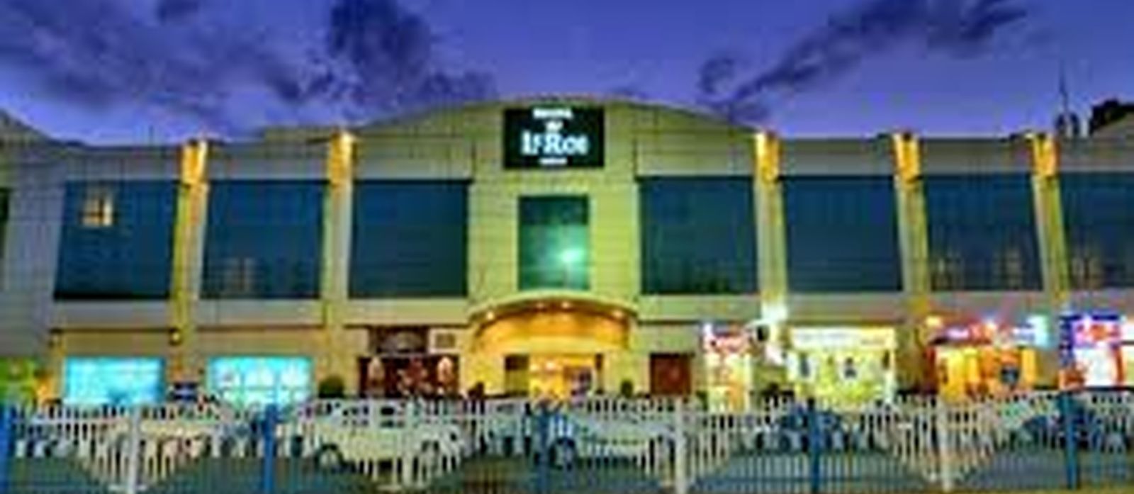 facade view of a hotel captured with night sky as the backdrop - le roi raipur hotel