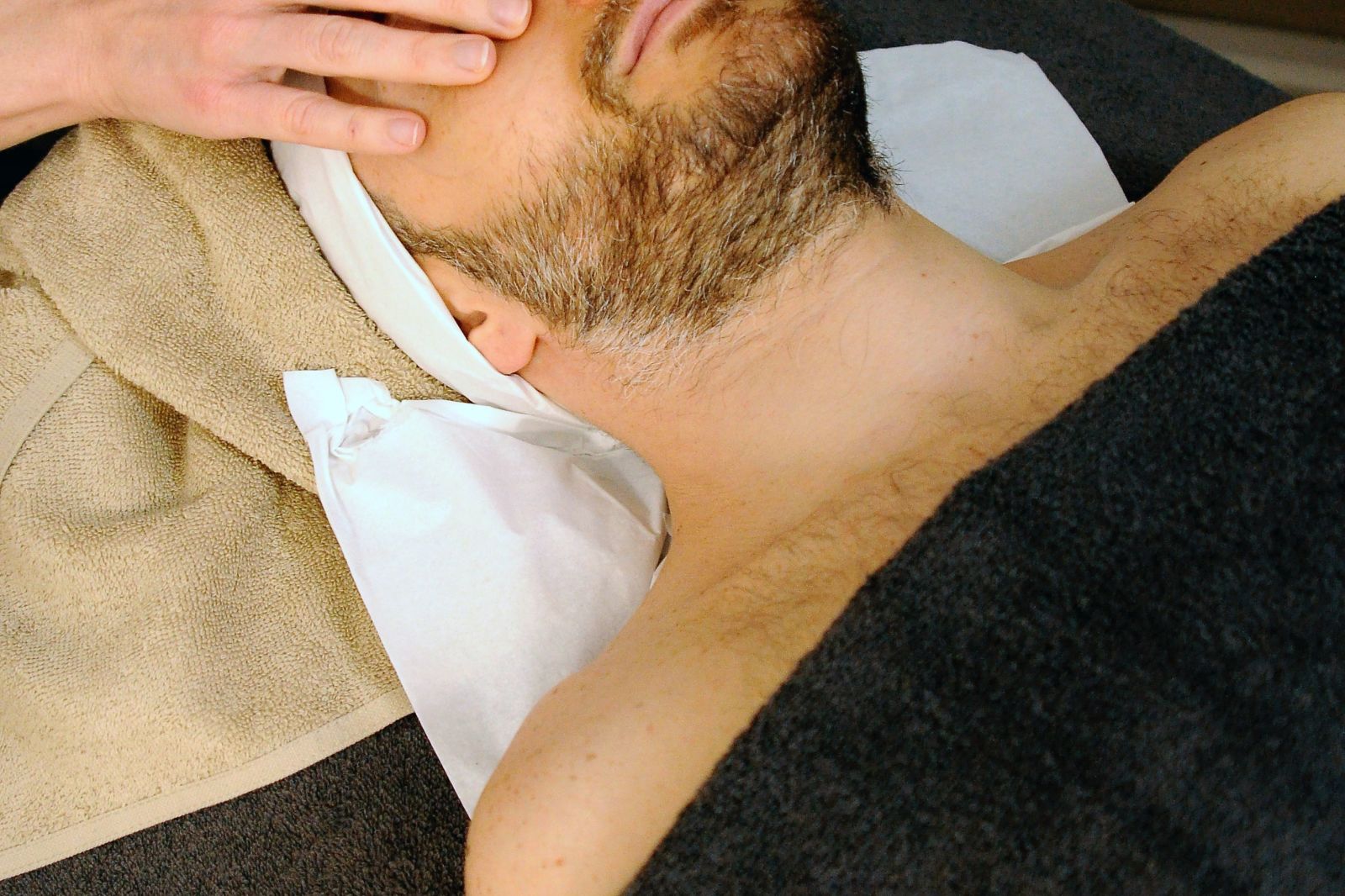 A person getting a face massage - Kerala Ayurveda