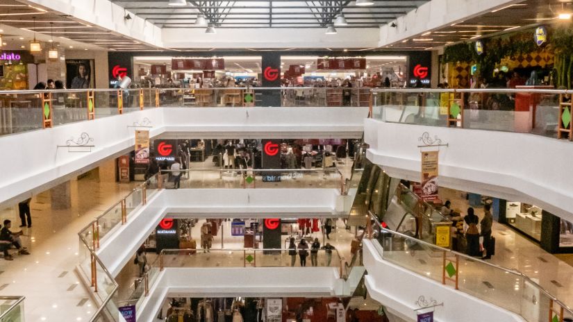 view of the different floors of a shopping mall with people crowding on every level