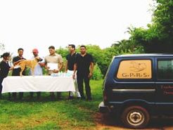 group of people standing besides a van