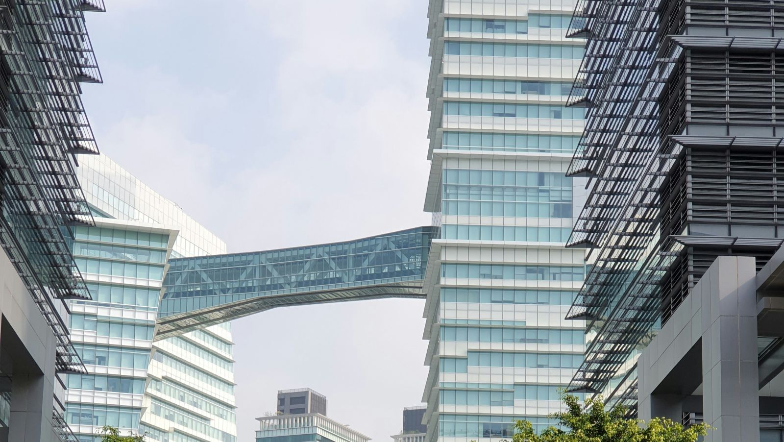 High rise buildings in the background with a person walking on a zebra crossing