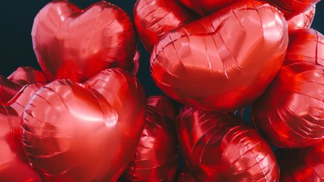 Inflated red coloured balloons in the shape of a heart