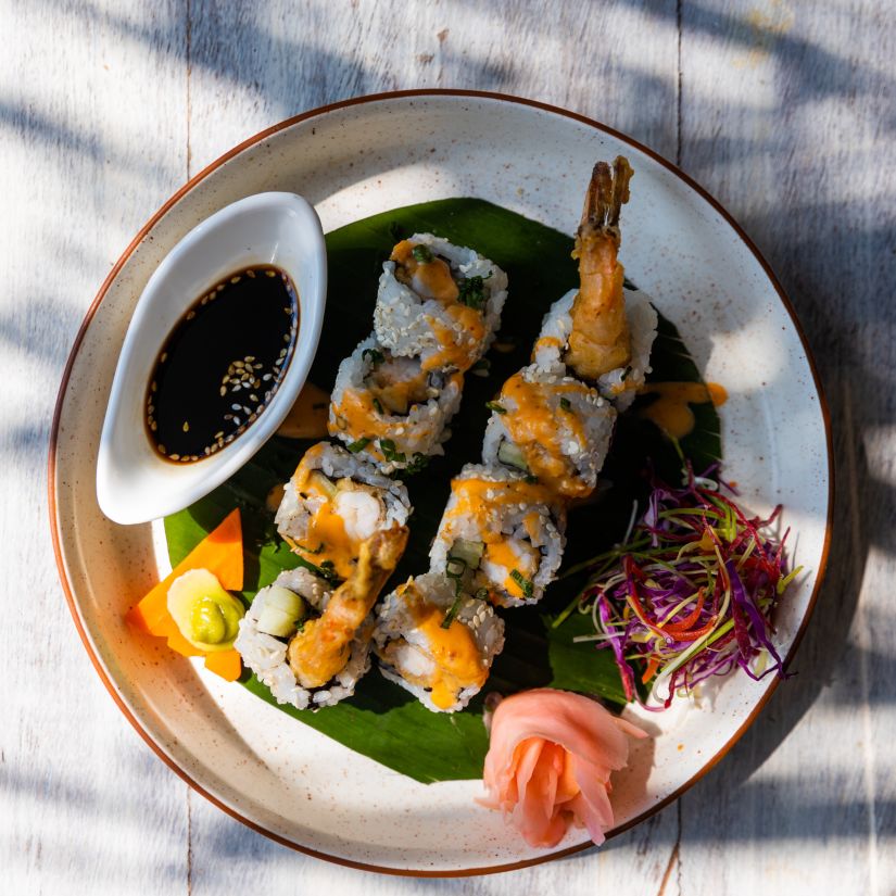 a plate of sushi and dip