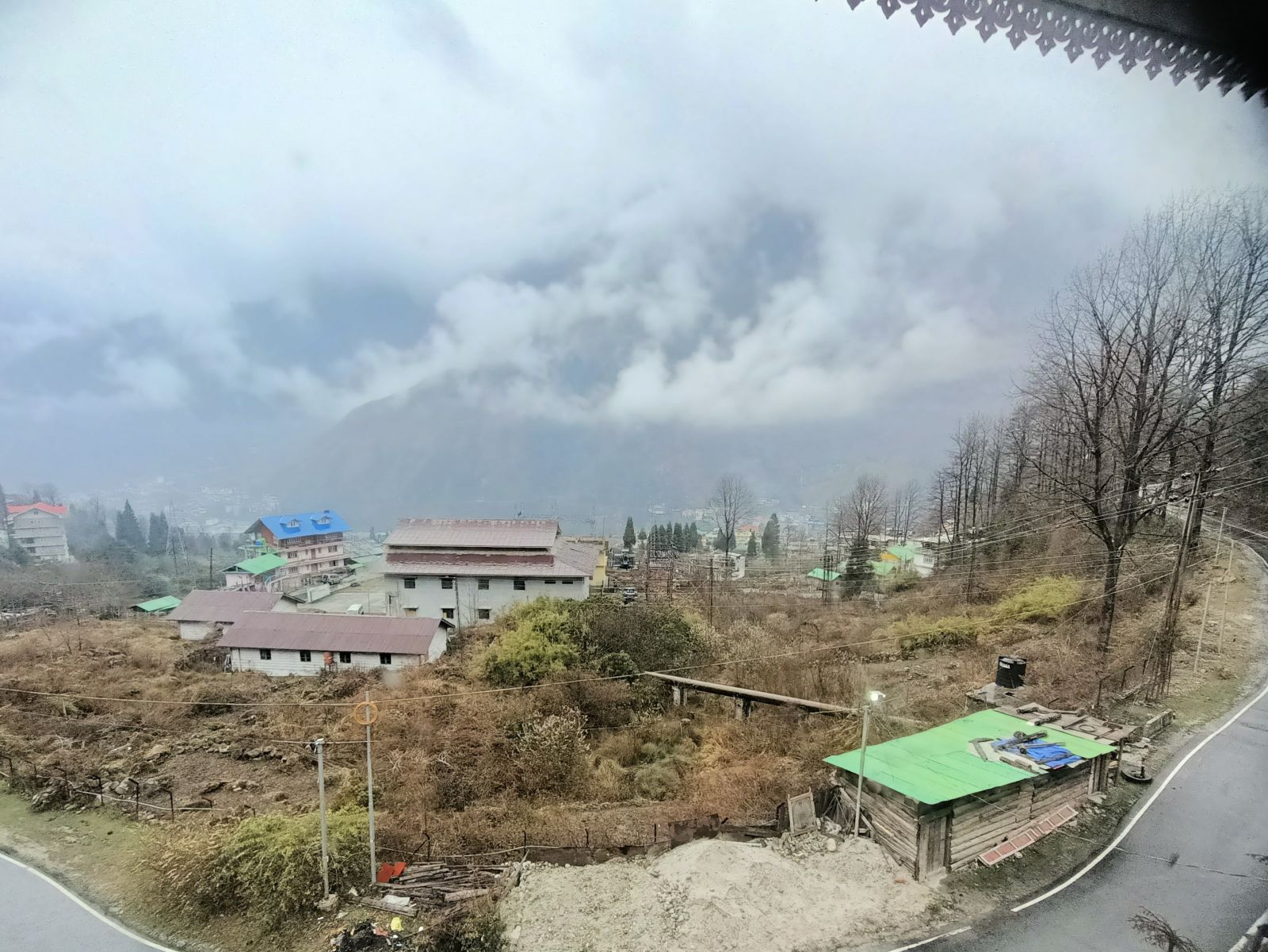 View of buildings and mountains from a balcony of our hotel