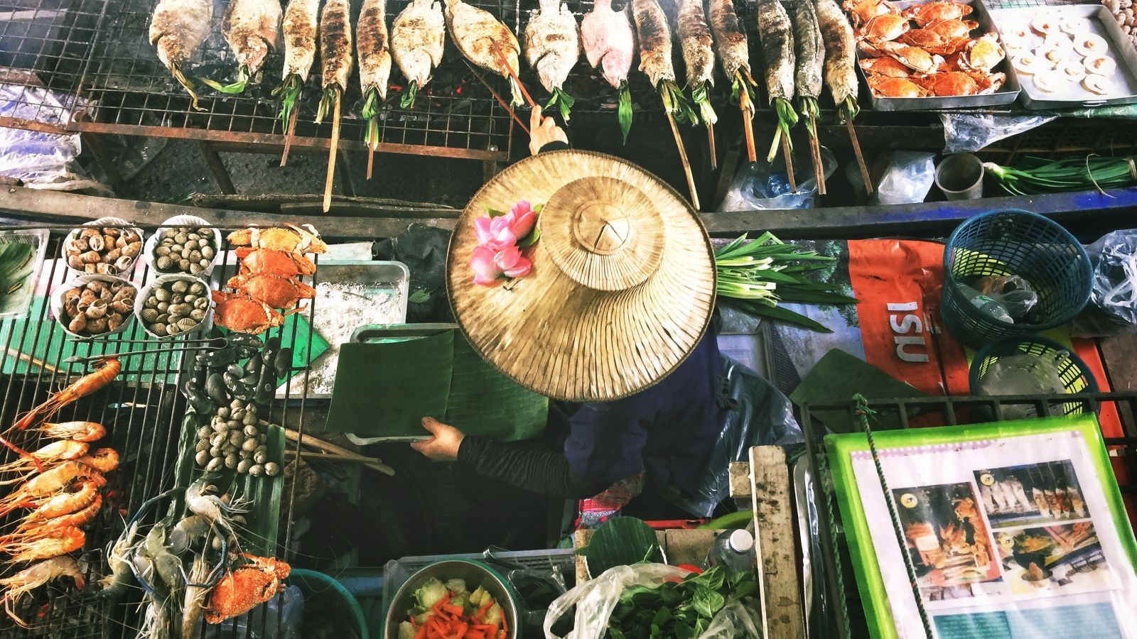 a woman cooking food at a street stall