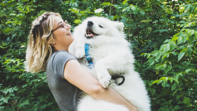 woman holding a large dog