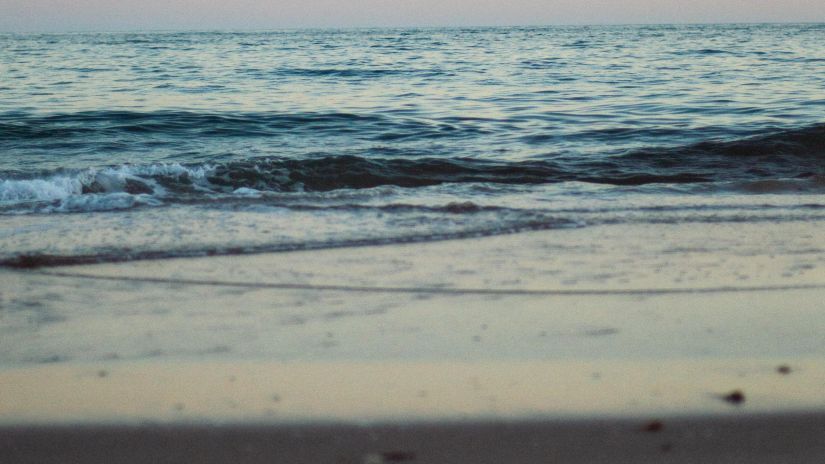 an overview of Galgibaga Beach, Goa in the evening with water overlapping the beach