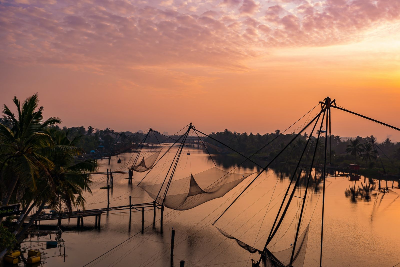 an image of the popular chinese fishing nets in kochi captured during sunset