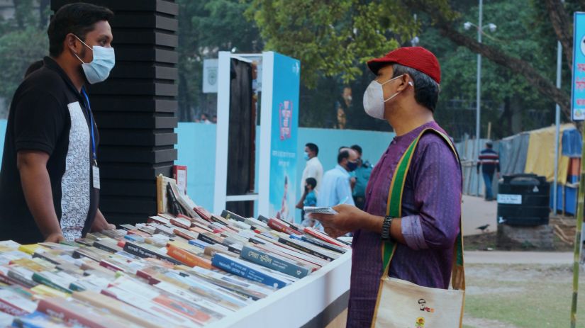 a customer looking at books at a book fair