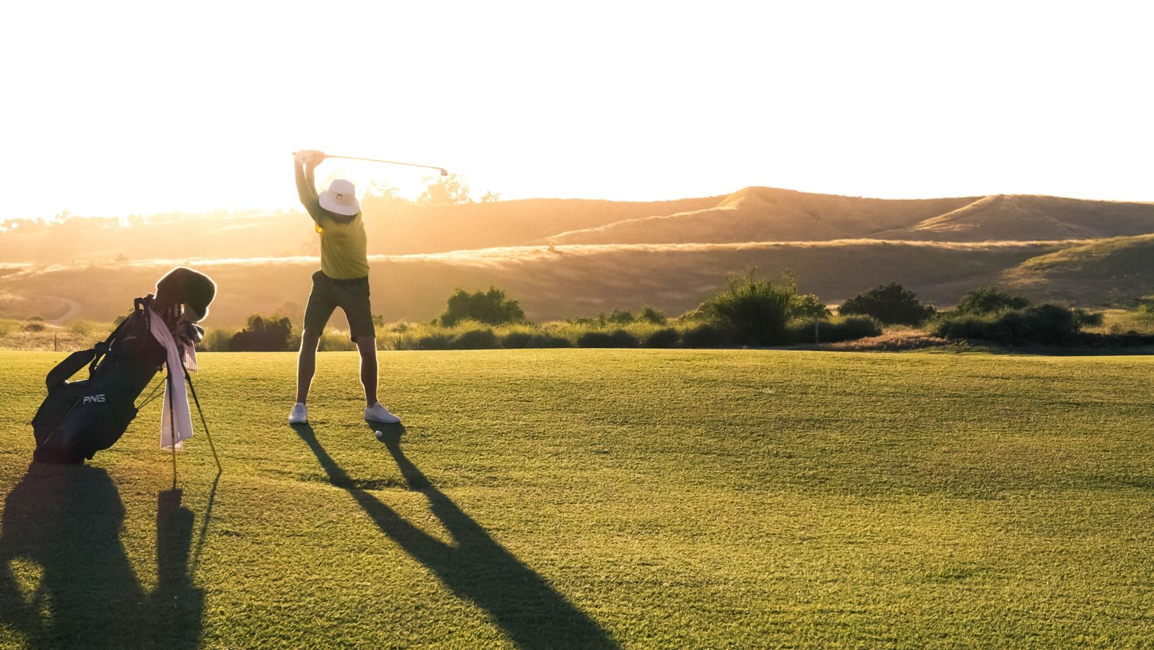 A man plays golf at a spacious lush green golf course - things to do in Whitefield Bangalore