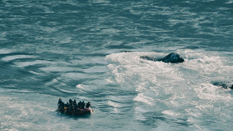 a group of people river rafting