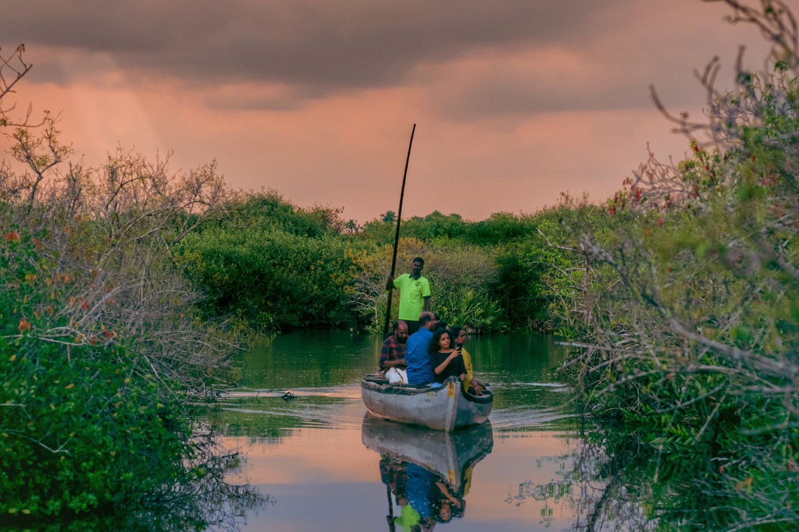 a group of tourists enjoying a boat ride in kerala backwaters