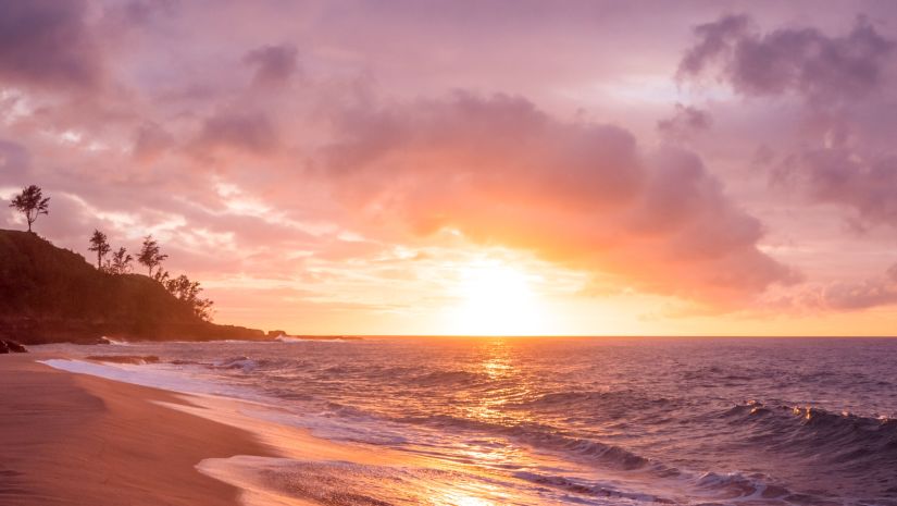 ocean waves glistening in golden hue during sunset