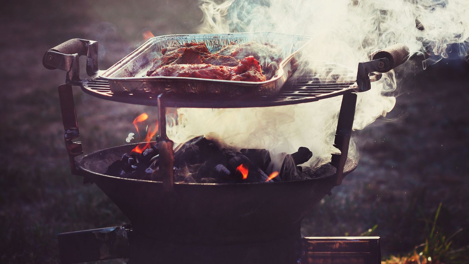 meat being cooked in a barbeque grill