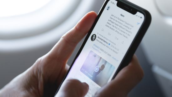 a person using a smart phone inside an aeroplane