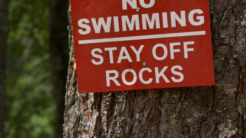 A No Swimming sign hangs on a tree - Symphony Summer Sand Beach Resort and Spa