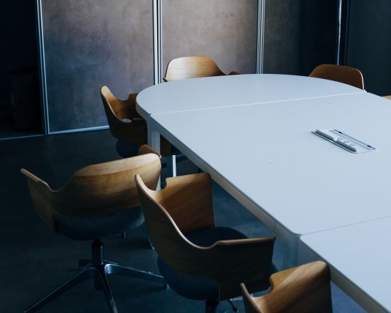 alt-text An empty meeting room with a table and chairs