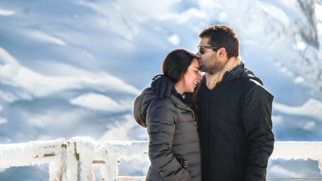 A couple with snow-capped mountains in the background
