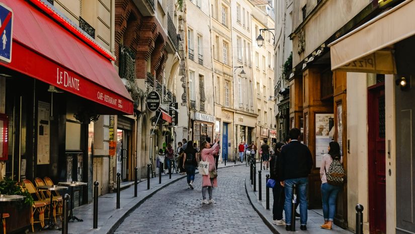 Cafes and restaurants on both sides of a narrow road