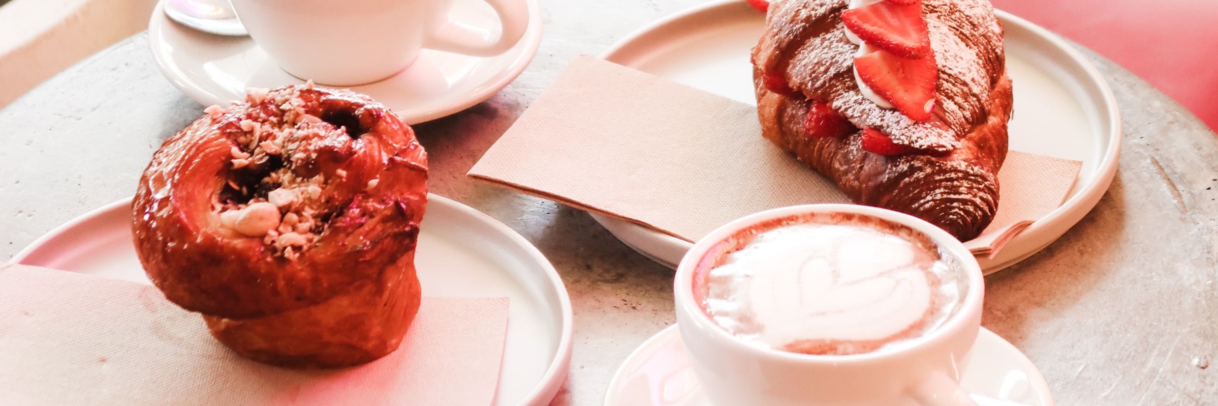 A cup of coffee and croissant kept on table  beautifully arranged