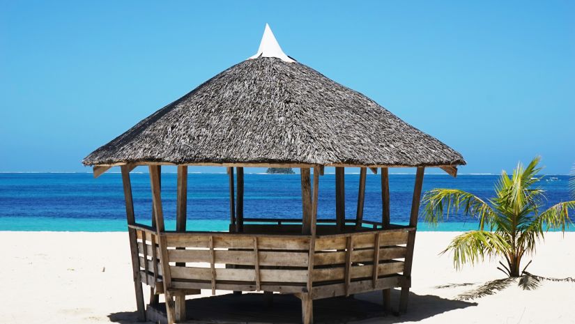 A shack on a beach with views of the beautiful sea