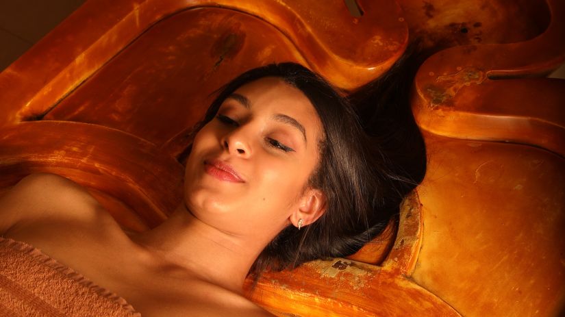 Woman enjoying hair treatment in spa at  a luxury resort in delhi