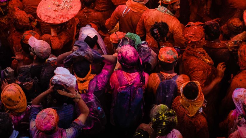 people celebrating with colours for holi