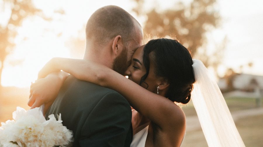 A couple hugging after their wedding